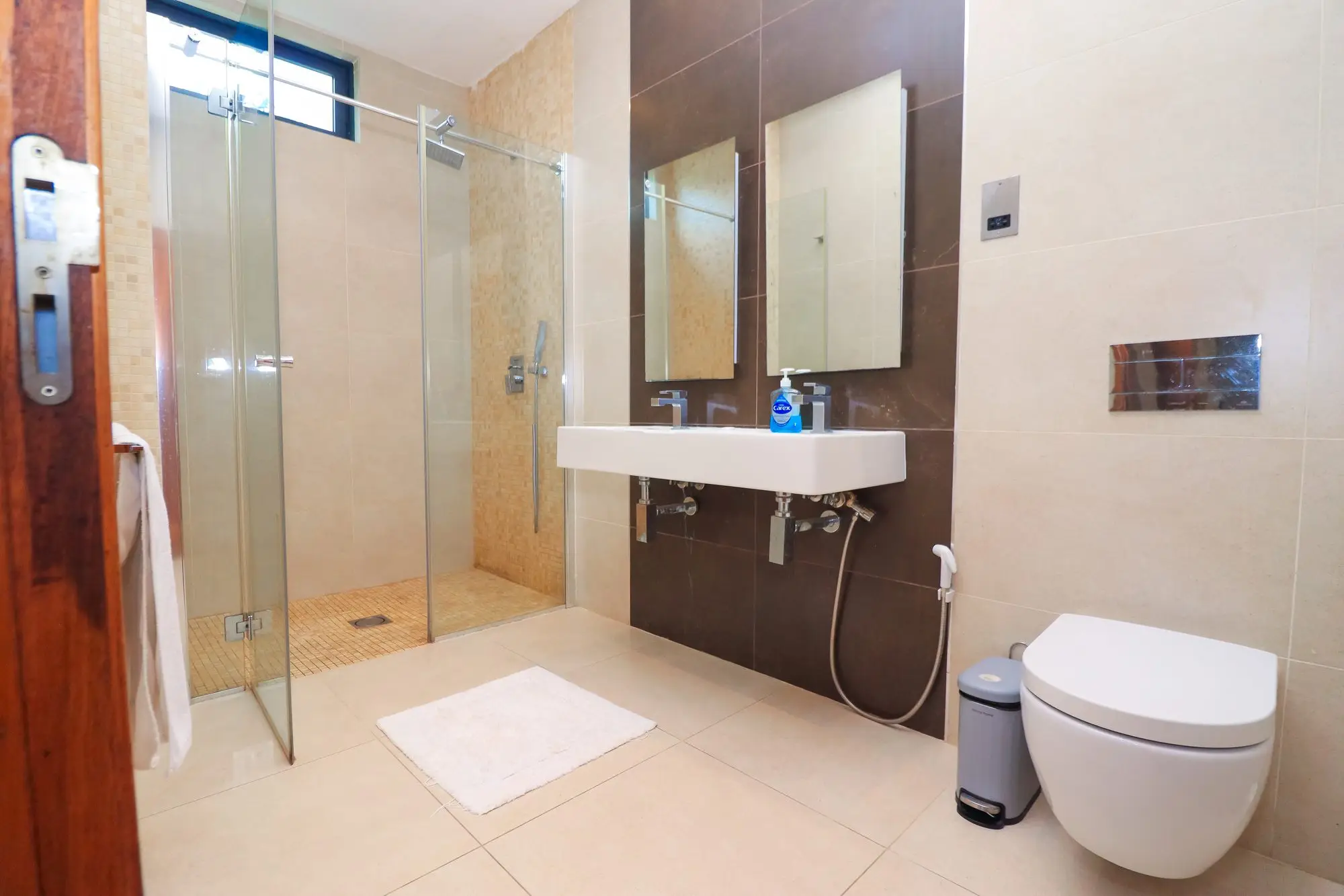 En-suite bathroom with walk-in rainfall shower at Nyali Marina Stays, Mombasa