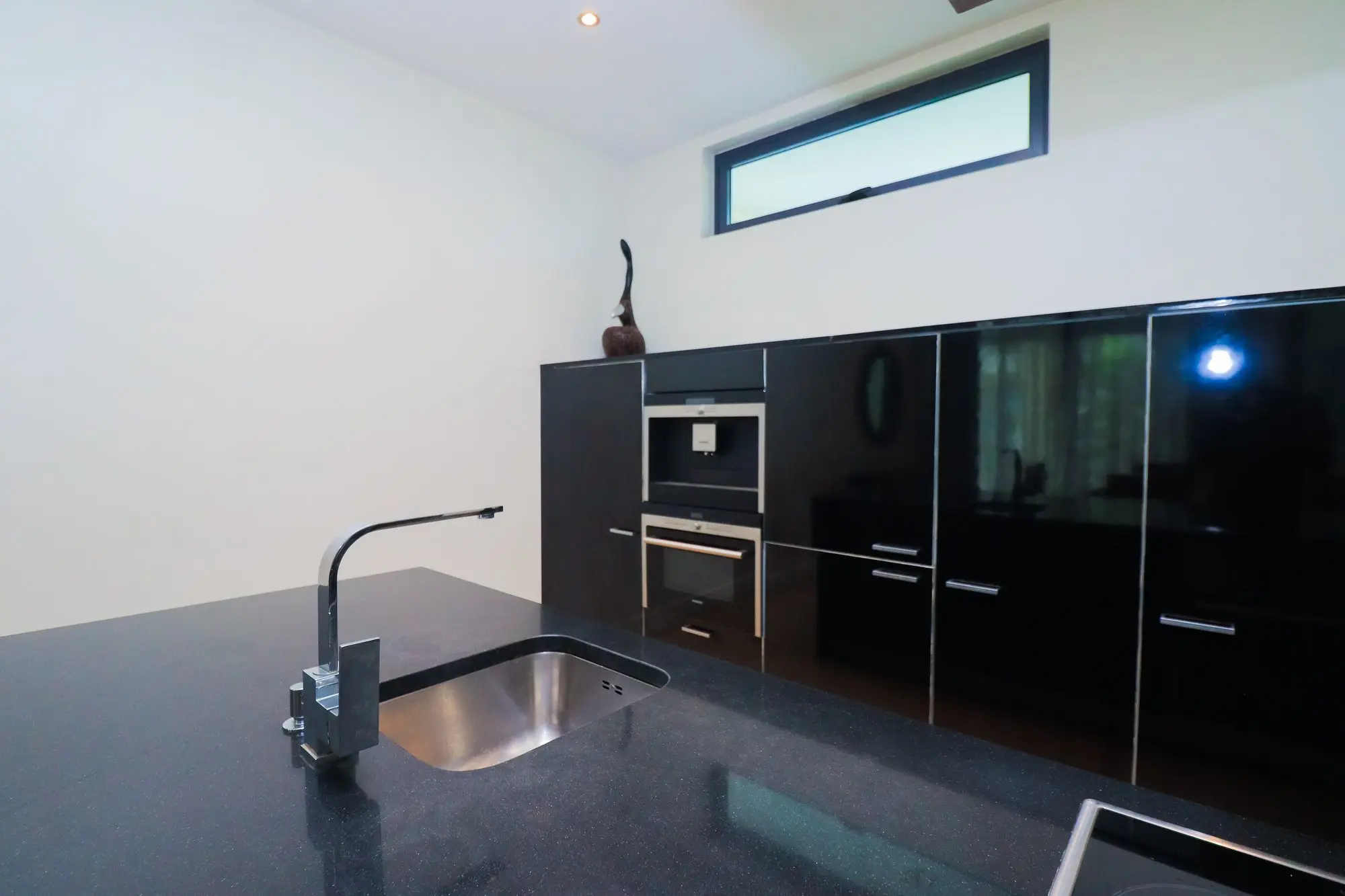 Modern fully fitted kitchen with black gloss units at Nyali Marina Stays apartment, Nyali